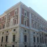 Siamo quindi davanti alla Banca d�Italia, che si sviluppa su quattro livelli, con una netta predominanza del colore bianco della pietra nella fascia inferiore e del rosso del rivestimento in laterizio in quella superiore. La facciata � caratterizzata da due ordini architettonici, dorico e ionico, uno zoccolo lapideo e un corpo aggettante